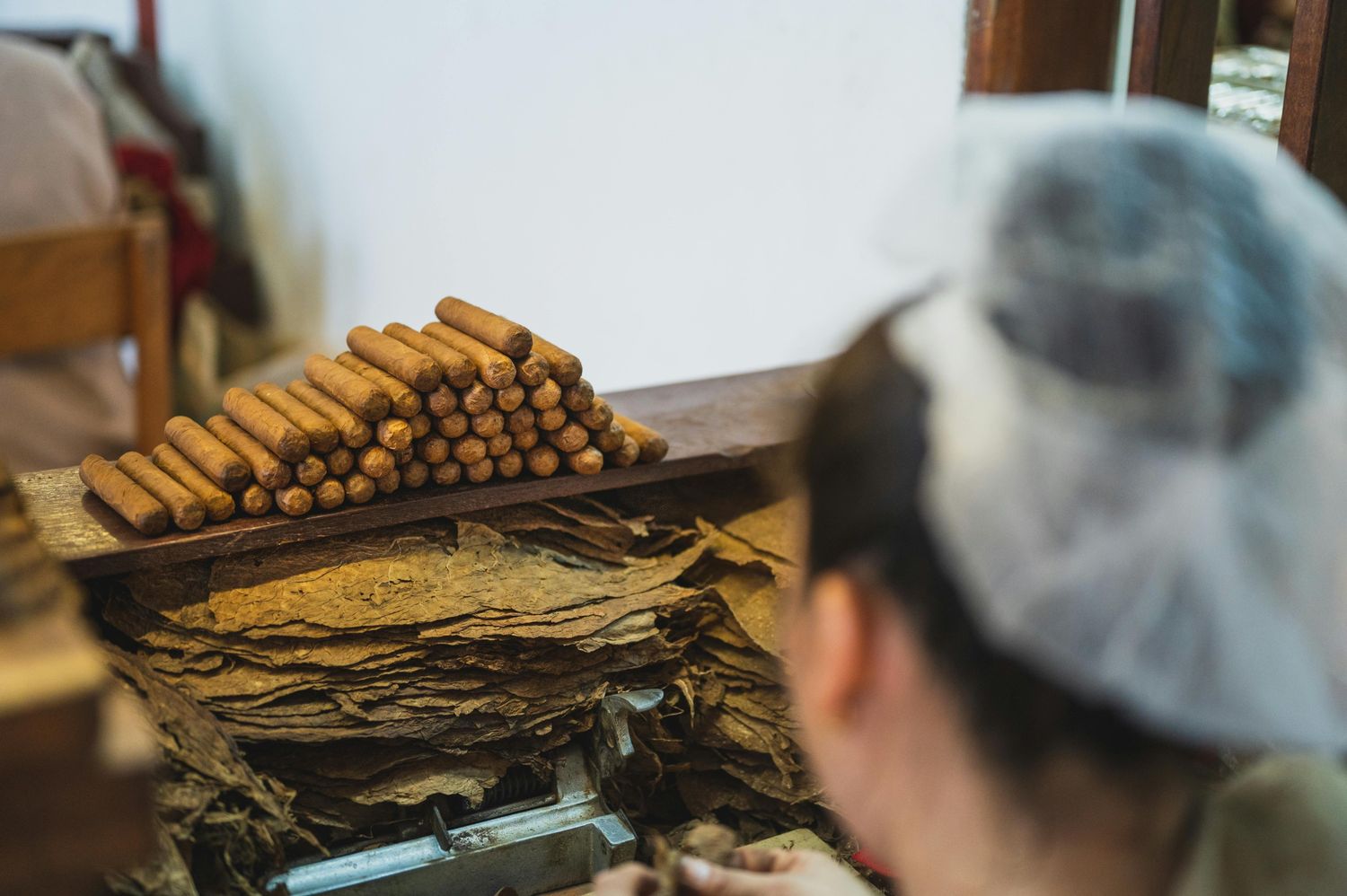 A wooden tobacco display with pipes and pouches, showcasing quality items at Tobacco Store Houston.