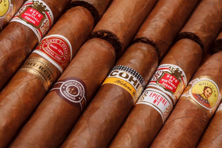 A selection of premium cigars with colorful bands, showcasing the finest collection at a cigar shop in Broken Arrow.