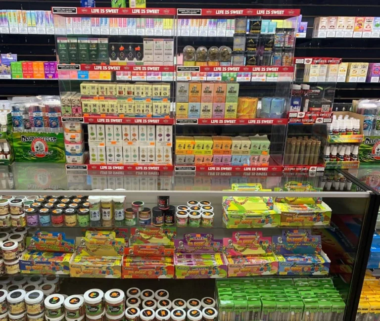 Well-stocked shelves with cigarettes, vapes, and candies at Cigarette Shop Tulsa, featuring different cigarette brands.