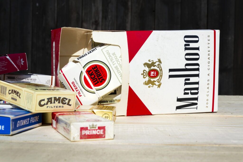 Assorted vintage cigarette packs including Marlboro, Camel, Lucky Strike, and Chesterfield from a cigarette shop in Houston.