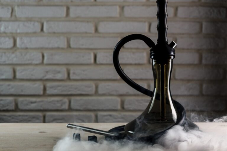 A sleek hookah with colorful smoke in a cozy lounge, available for enjoyment at a hookah shop in Broken Arrow.