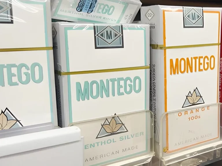 Storefront of a cigarette shop in Houston with neon sign and display window showcasing tobacco products.