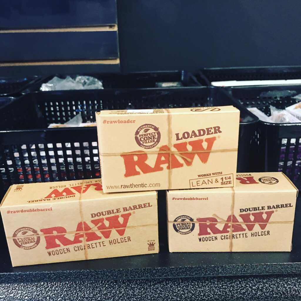 RAW wooden cigarette holders in boxes displayed at a busy Tobacco Shop Houston.