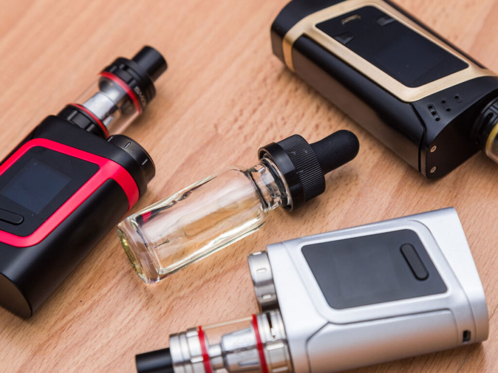 Variety of vape mods and e-liquid bottles at a leading vape shop in Tulsa, highlighting quality products for an enhanced vaping experience.