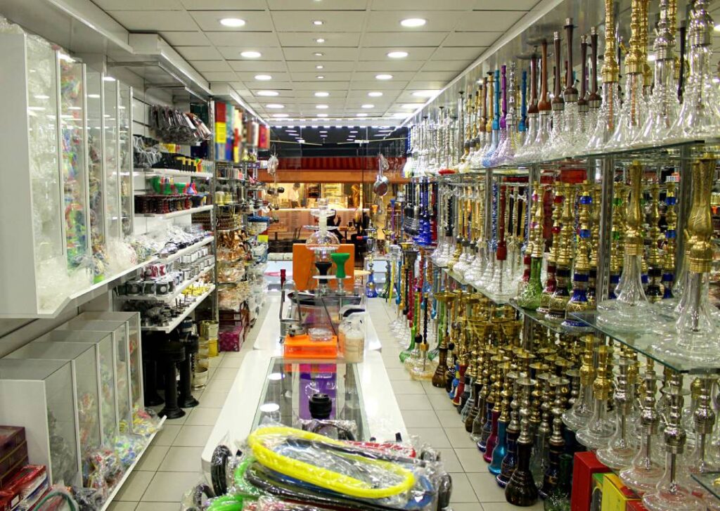 Colorful hookahs and smoking gear in organized retail layout—diverse selection at Head Shop Sapulpa.