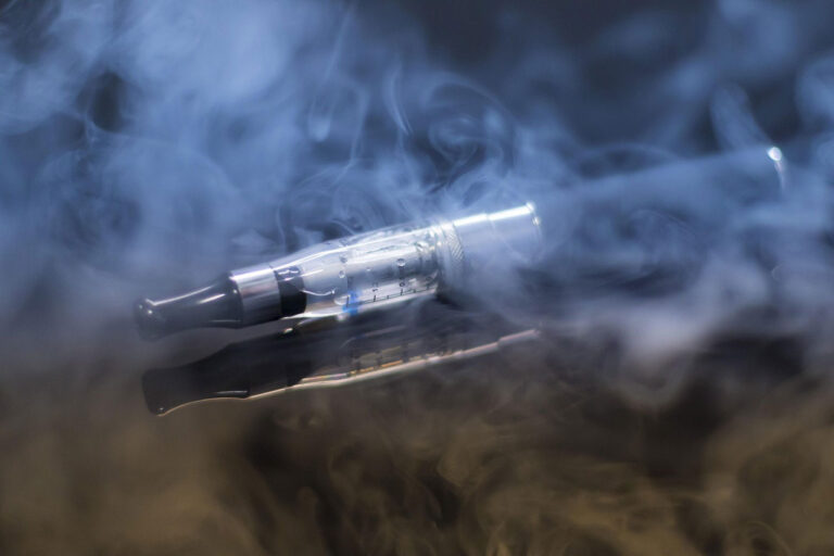 Clear vape tank atomizer surrounded by dense vapor clouds, find quality vape liquid near e-cigarettes broken arrow.