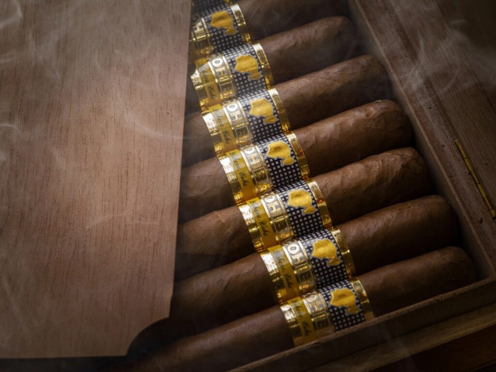 Luxury cigars with African-themed bands in a smoky wooden box—shop premium blends at a top cigar store in Owasso.