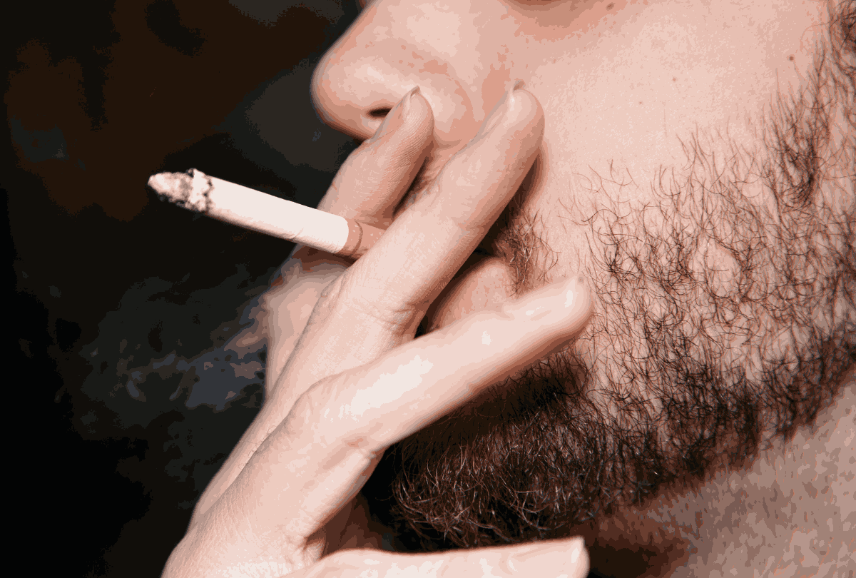 Close-up of smoker exhaling tobacco smoke—authentic moment captured for Tobacco Store Sapulpa’s product showcase.