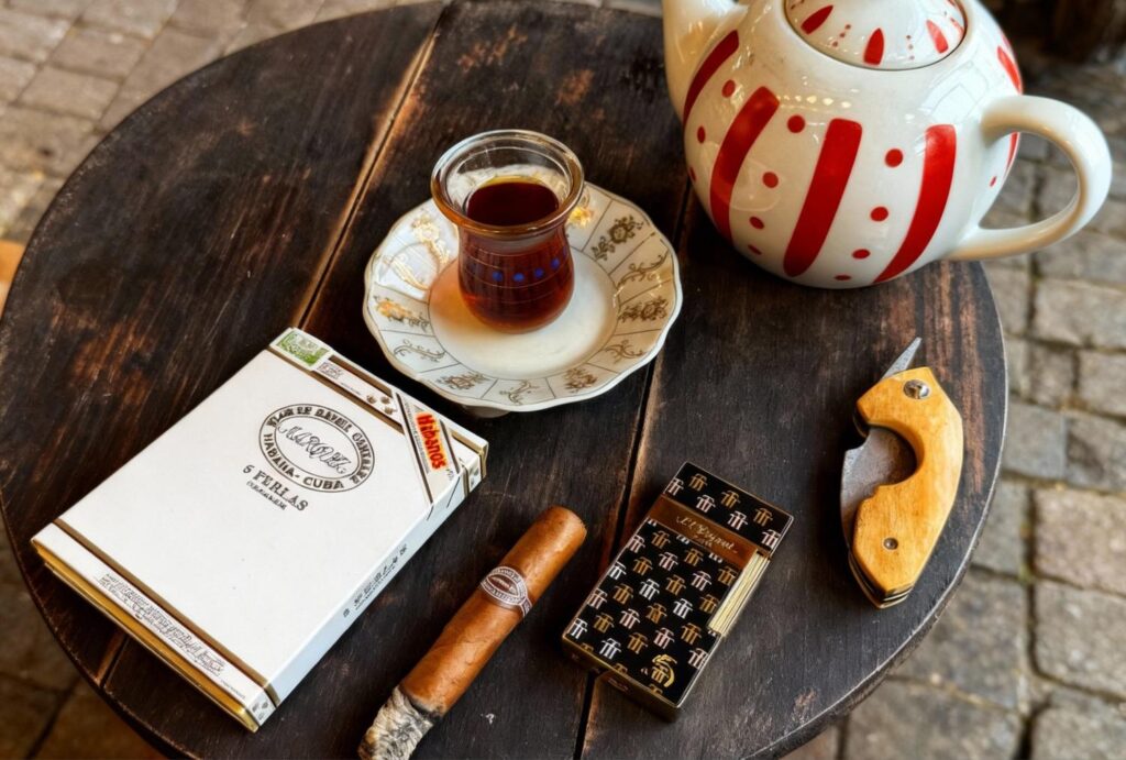 Romeo y Julieta Cuban cigar with Turkish tea and cutter on table – Cigar Store Owasso vibes.