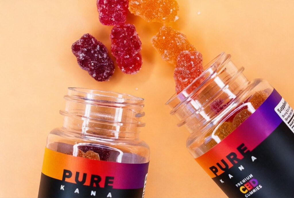 Pure Kana premium CBD gummies pouring from vibrant bottles at CBD Store Sapulpa.