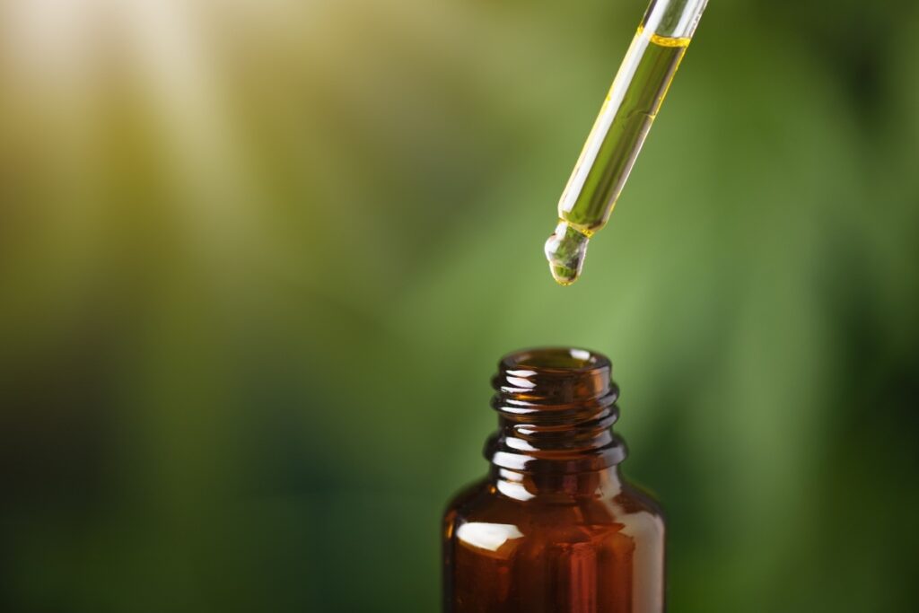 High-potency golden CBD oil being dropped into a bottle from a trusted CBD Shop Tulsa.