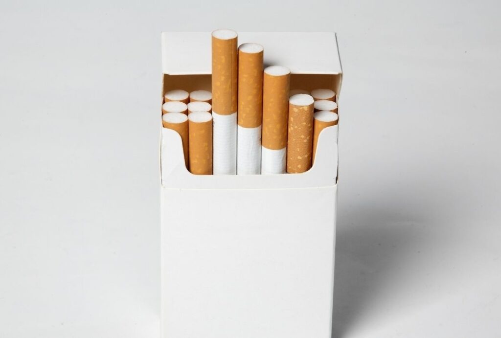 Open white cigarette pack with brown filters featured in cigarette shop Tulsa product showcase for tobacco buyers.