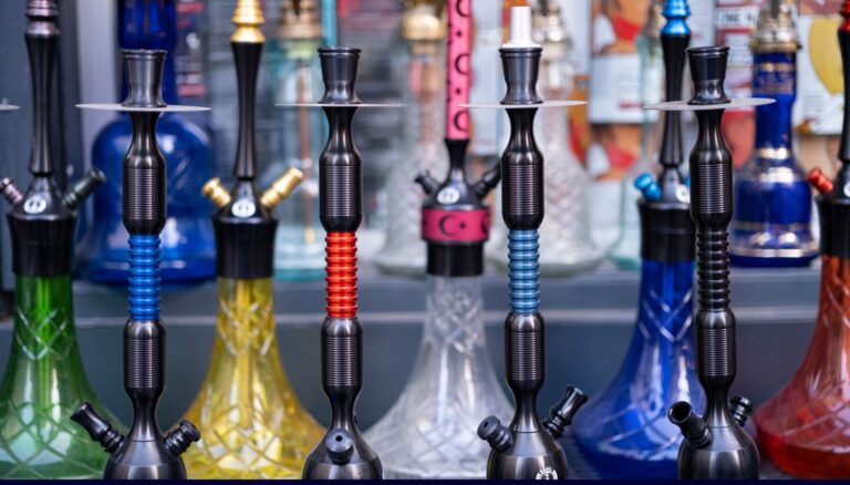 Row of modern black and colored hookahs on display at a well-stocked Head Shop Houston.
