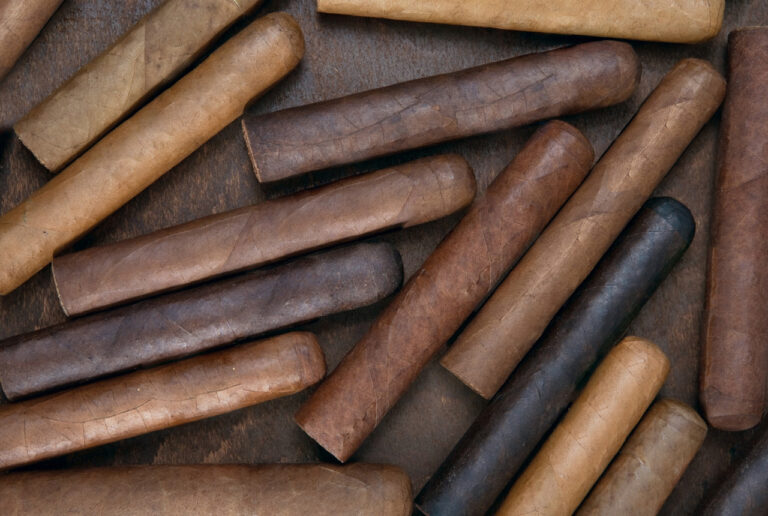 A diverse collection of hand-rolled cigars in various shades and sizes available at the best cigar shop Owasso has.