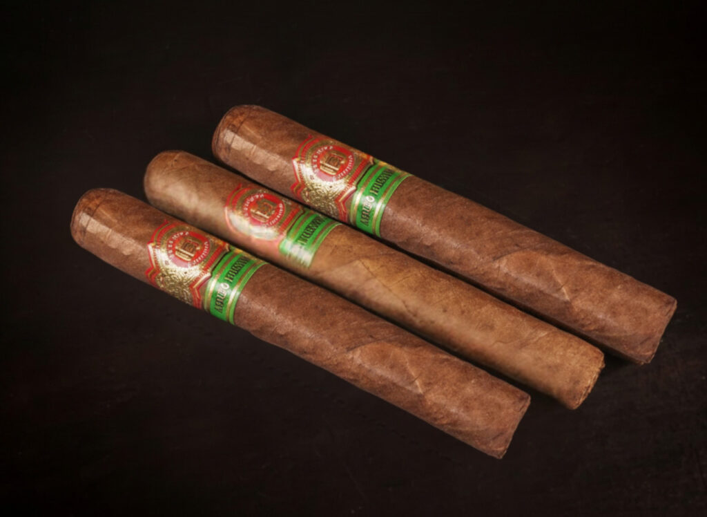 Three distinctive premium cigars, showcasing dark and light wrappers, available for purchase at an elite cigar shop Houston.