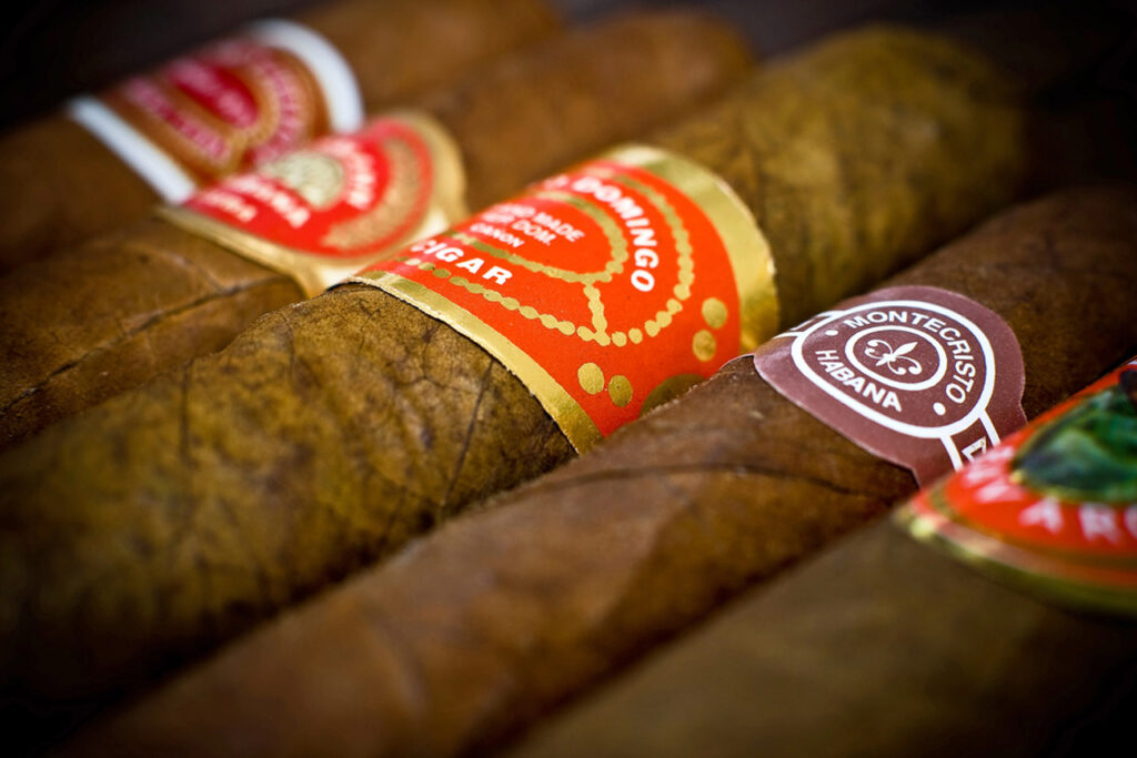 Close-up of premium Cuban cigars including Montecristo and H. Upmann at top cigar shop Broken Arrow.