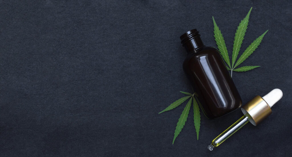 Dark bottle of potent CBD oil tincture and dropper. Find this product at your local CBD shop Owasso.