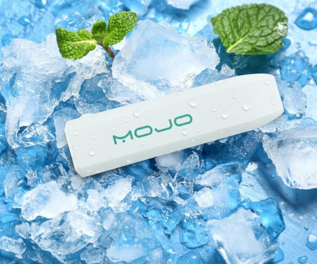 Menthol Ice Mojo disposable vapes Owasso device displayed on crushed ice with fresh mint leaves for a refreshing look.
