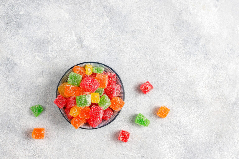Sugar-dusted multicolored Delta 8 gummies in bowl at top Delta 8 store Broken Arrow.