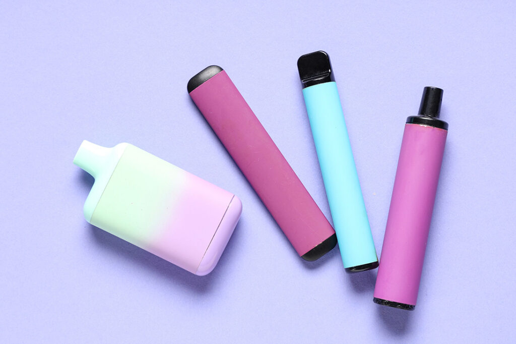 Top-down view of three stylish disposable vapes showing flavors, available now at your local vape shop Tulsa.