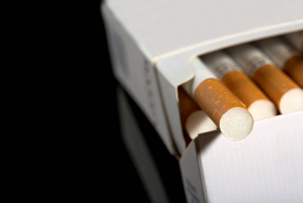 Close-up of open cigarette pack on black backdrop, high-quality filtered tobacco product from a top tobacco shop Tulsa.