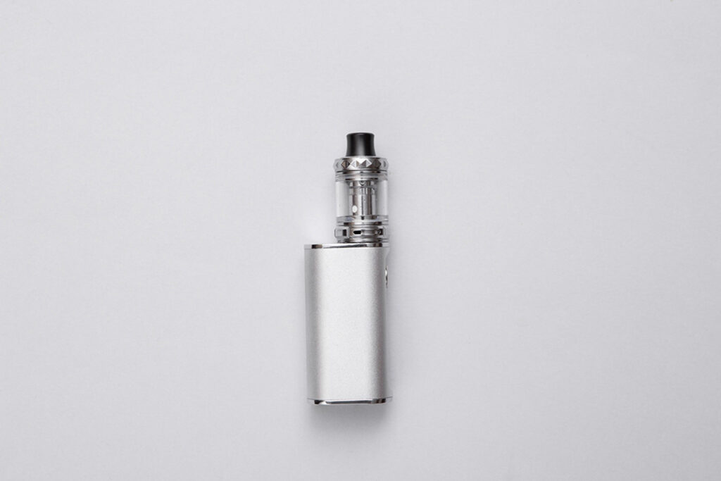 Top-down view of a complete silver box mod and clear tank vape kit, an essential item at any vape shop Tulsa.