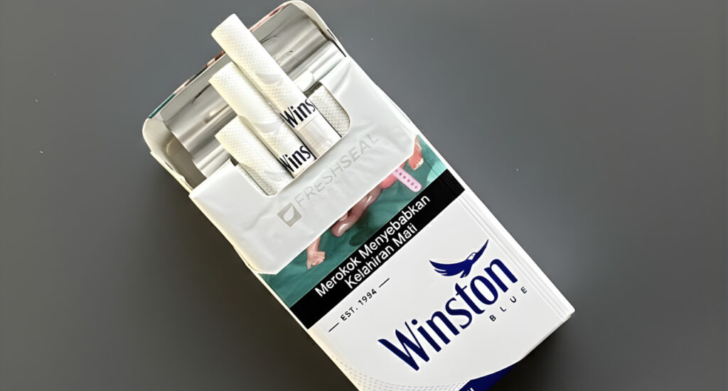 A pack of Winston Blue cigarettes at a cigarette shop Tulsa featuring a fresh seal lid and Indonesian health warnings.