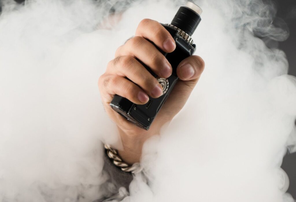 Handheld high-power box mod producing thick vapor clouds from the best vape shop Tulsa OK hardware selection.