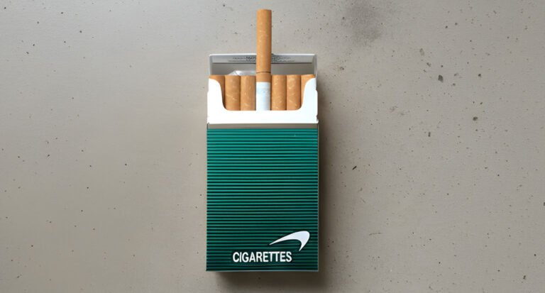 Open pack of Newport menthol cigarettes from a tobacco store Houston, featuring a single cigarette standing upright.