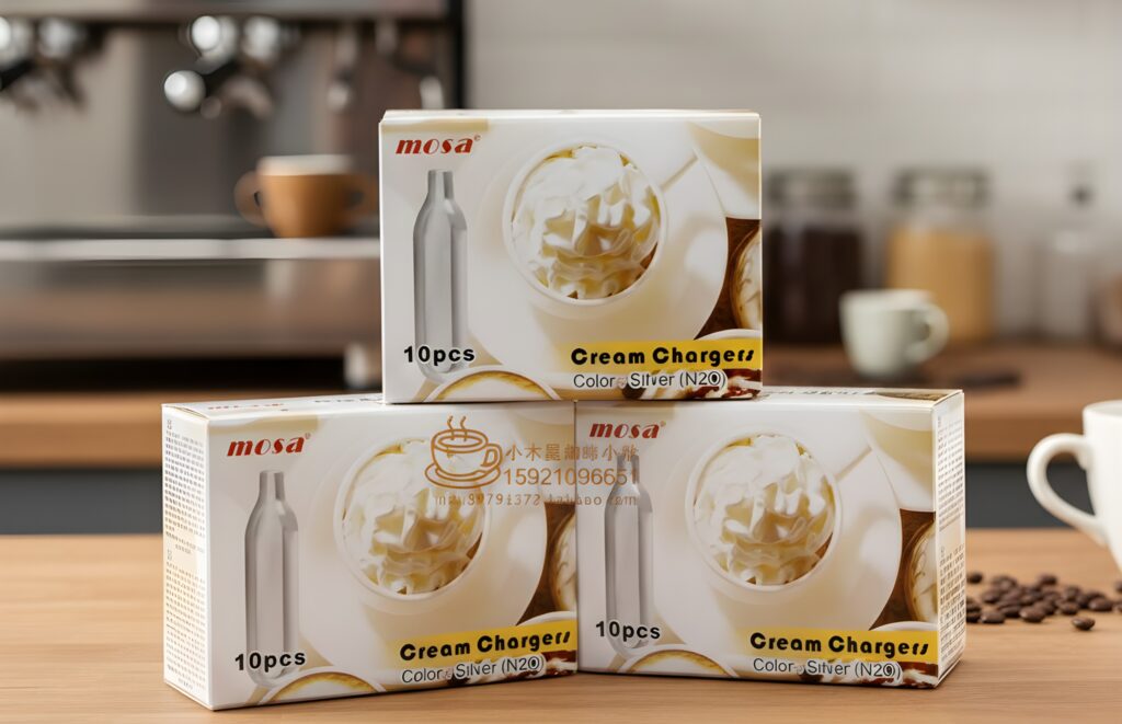 Stack of Mosa 10pc cream chargers n20 Owasso on a wooden table near an espresso machine and coffee beans in a cafe.