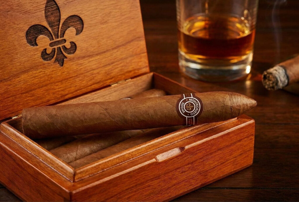 Premium Montecristo cigar on a branded wooden box with whiskey, a selection for a top cigar shop in Broken Arrow.