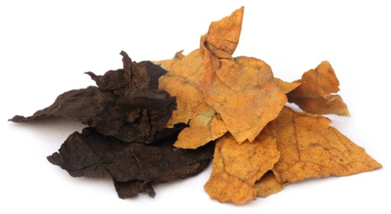 Heap of dark and light air-cured whole leaf tobacco, perfect for custom blends from our local tobacco shop Sapulpa.