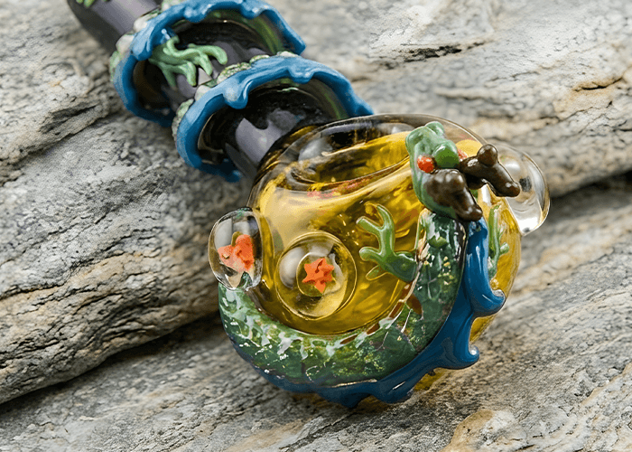 Handcrafted ocean wave dragon themed glass pipes Tulsa with blue water ripples and sea creature glass art details.