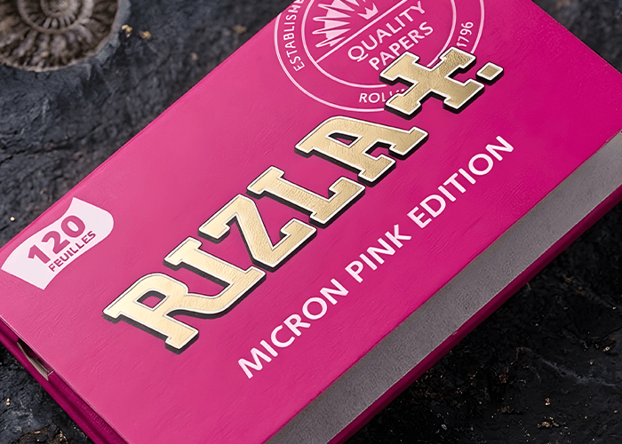 Rizla Micron Pink Edition 120 leaves pack on stone background, premium rolling papers Tulsa smoke shop supply.