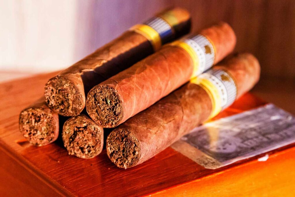 A stack of premium quality hand-rolled tobacco cigars from an authentic cigar and cigarette shop Houston boutique.