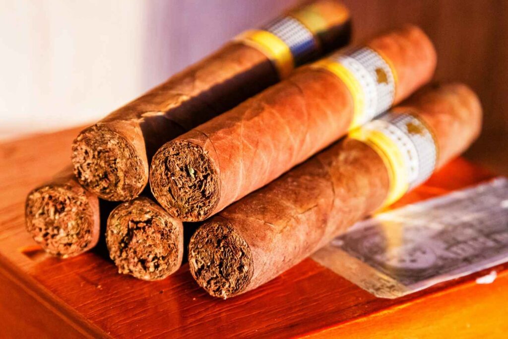 Close up of premium hand-rolled tobacco cigars lined up on display inside a cigar shop Broken Arrow. 