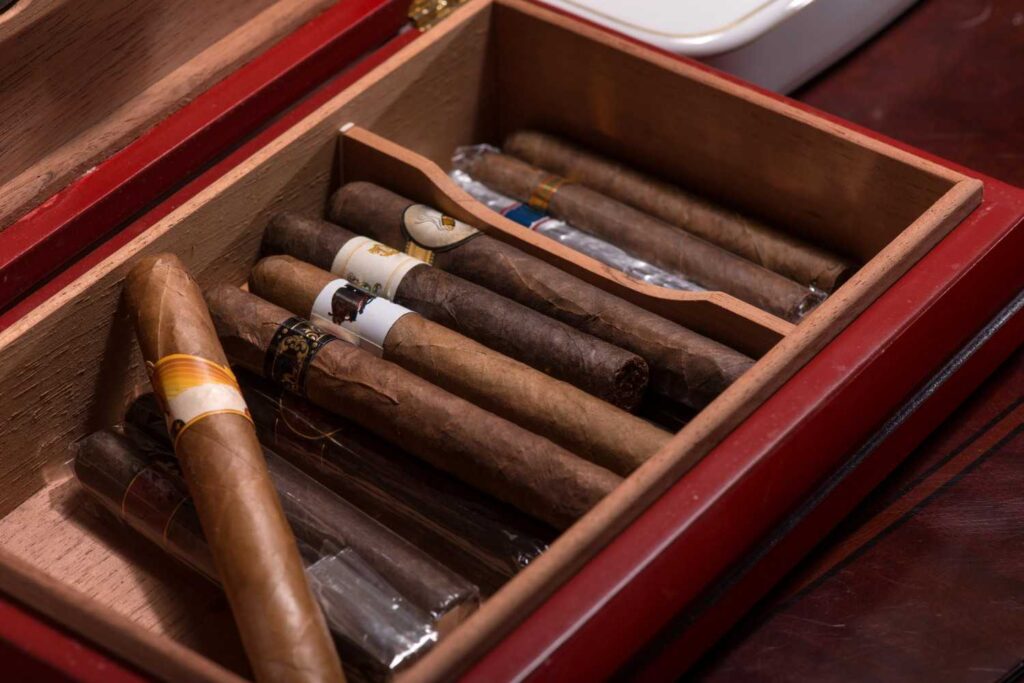 Premium wooden humidor selection filled with hand-rolled cigars at a local cigar shop Broken Arrow. 