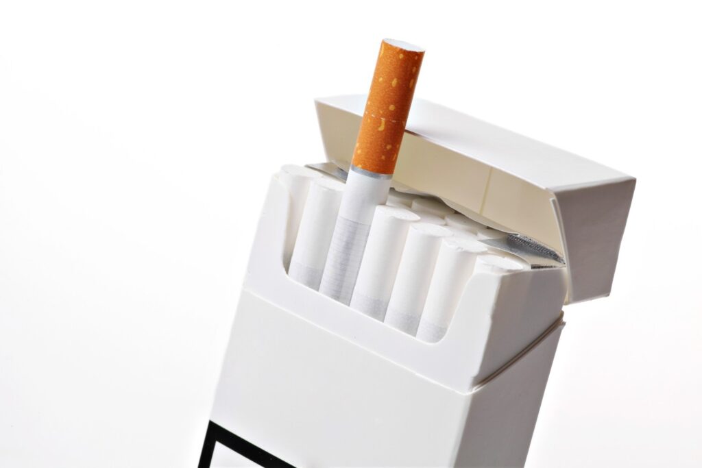 White box from a cigarette shop Tulsa featuring white filters with one brown filter cigarette flipped upward.