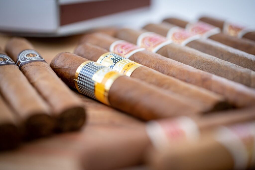 Premium hand-rolled cigars on display at a local cigar shop Sapulpa featuring iconic yellow and black Cohiba bands. 