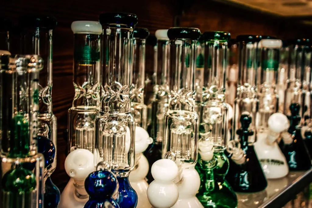 Rows of high-quality glass water pipes showcased on shelves at a premier head shop Tulsa retail store.