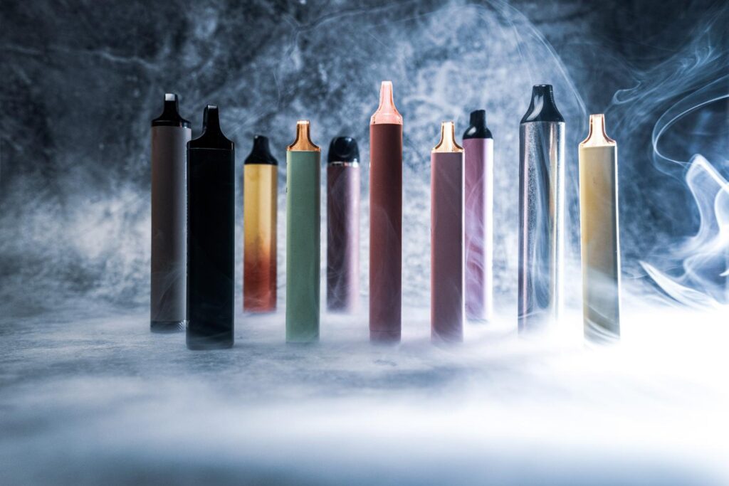 A diverse selection of colorful disposable vapes and nicotine pods Tulsa customers can find in a local smoke shop.