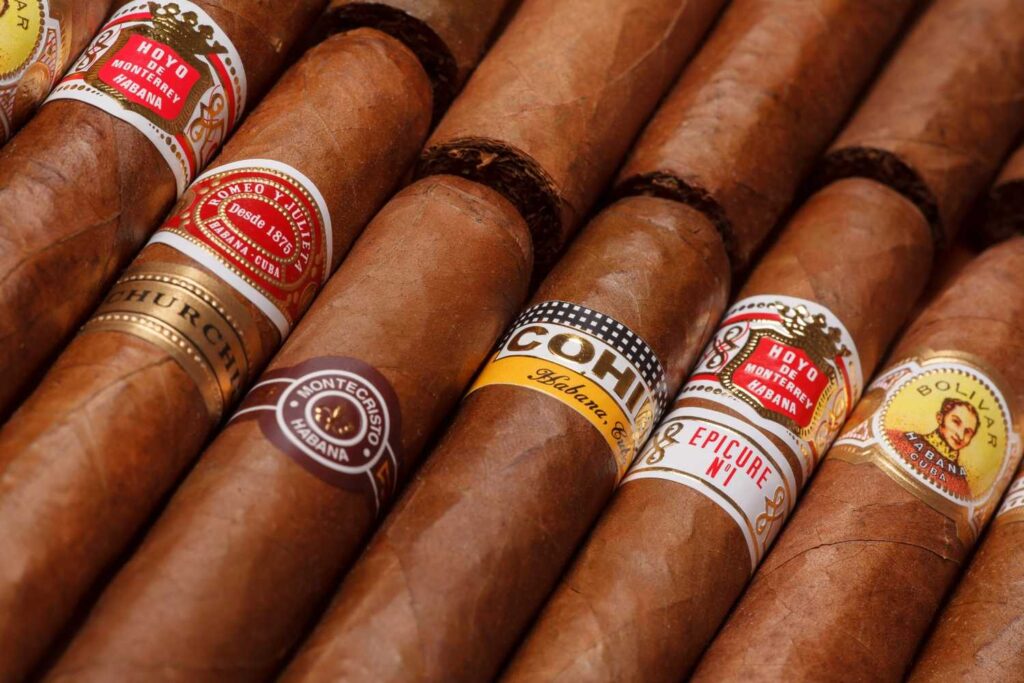 Close-up of Hoyo de Monterrey and Montecristo cigars in a humidor at the best cigar shop Sapulpa has for enthusiasts.