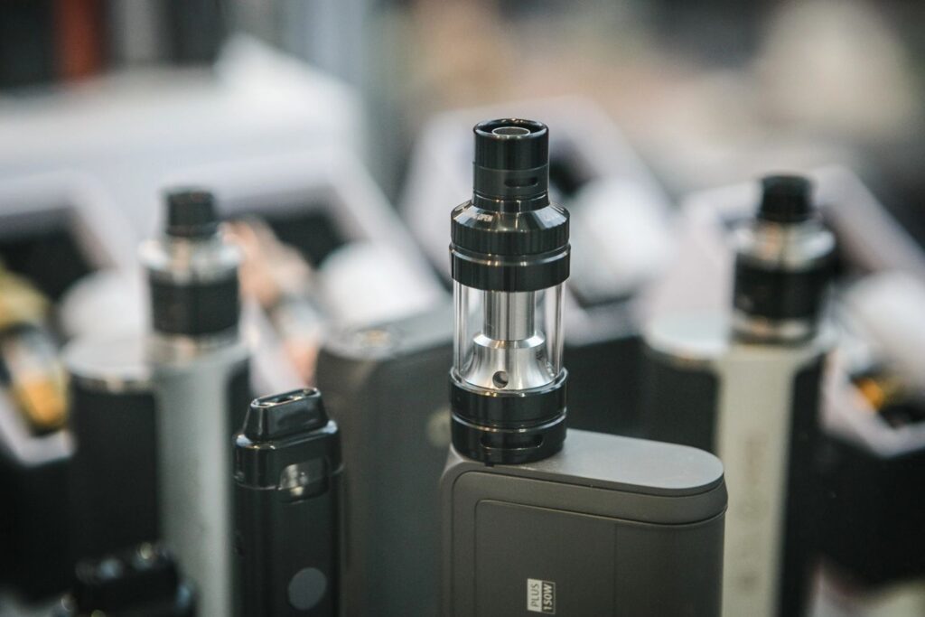 High-end premium vape mods Owasso retail display featuring a clear sub-ohm tank and sleek adjustable digital mod. 