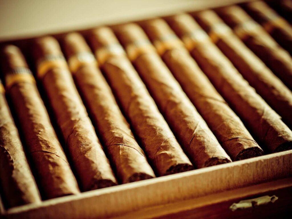 A freshly opened wooden box of premium hand-rolled cigars available at a top smoke shop Sapulpa spot.