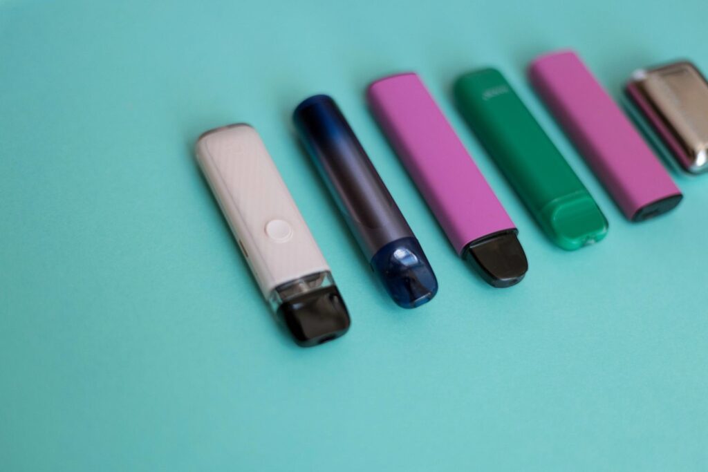 An organized row of sleek refillable pod systems and premium nicotine pods Tulsa residents use for modern vaping.