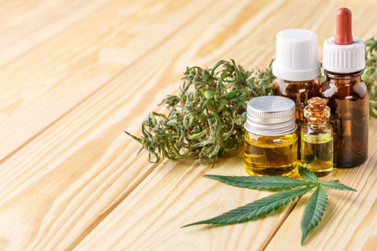 Premium organic medical oil droppers and fresh cannabis leaves featured at a cbd shop Tulsa.