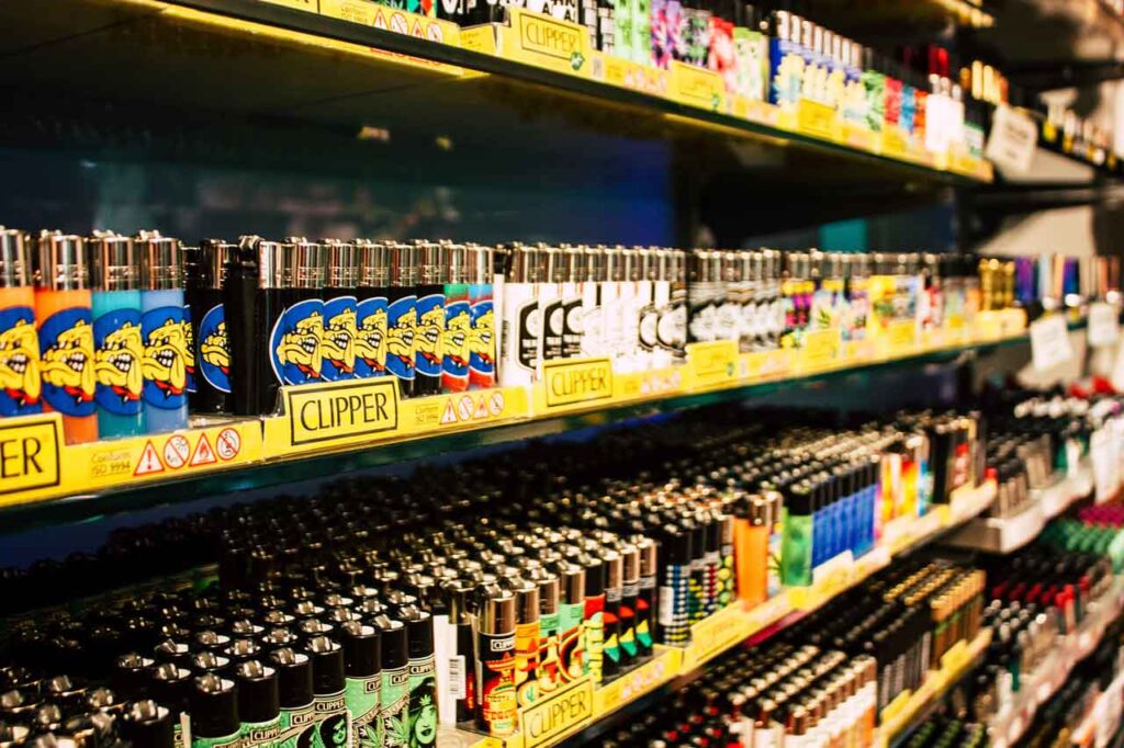 lose up of collectible Clipper lighters with cartoon dog designs on display shelves at a top smoke shop Tulsa store.