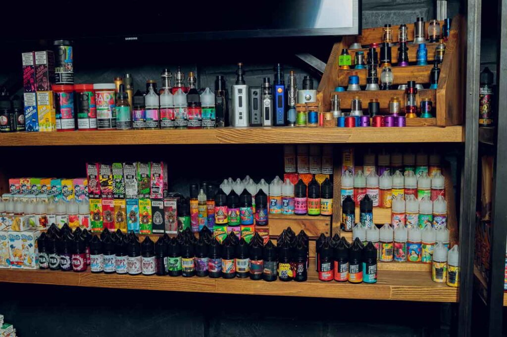 Well stocked shelves of premium vape juices e liquids and vaporizers inside a premium cannabis smoke shop Tulsa boutique.