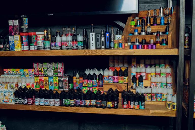 Well stocked shelves of premium vape juices e liquids and vaporizers inside a premium cannabis smoke shop Tulsa boutique.