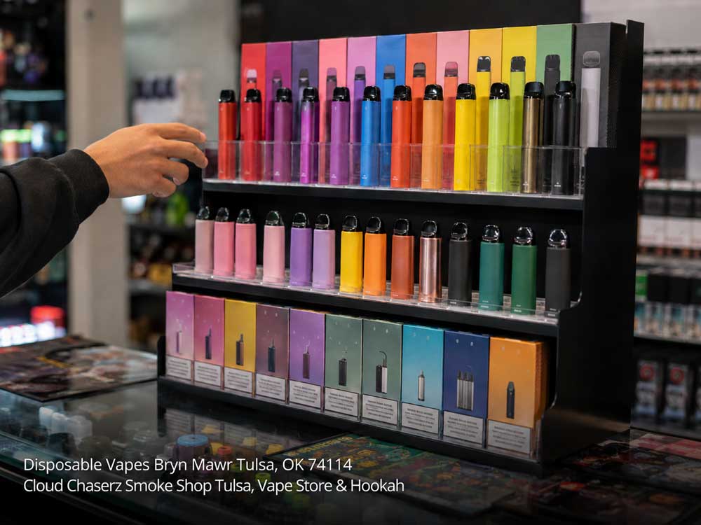 Hand selecting colorful disposable vapes Tulsa at a local smoke shop display stand with a broad flavor selection.